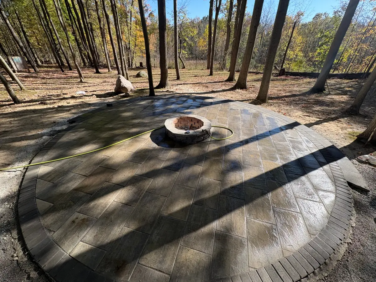 Circular paver patio with built-in fire pit built by Bauer Landscape
